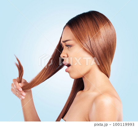 Hair, problem and woman with hair loss in studio for beauty, grooming and haircut on blue background. Damaged, haircare and girl model worried, unhappy or upset with keratin results while isolated 100119993