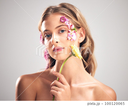 Beauty, flower and portrait of woman in studio with a skincare, natural and face routine. Floral, health and female model with organic, self care and fresh skin or facial treatment by gray background 100120065