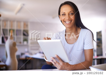 Im running her own boutique. Shot of a beautiful seamtress in her boutique. 100120102