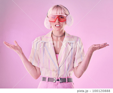 Confused, angry and portrait of a woman with fashion isolated on a pink background in a studio. Anxiety, sad and stylish girl model wearing ear muffs while frustrated with anger and a problem Confused, angry and portrait of a woman with fashion isolated on a pink background in a studio. Anxiety, sad and stylish girl model wearing ear muffs while frustrated with anger and a problem 100120888