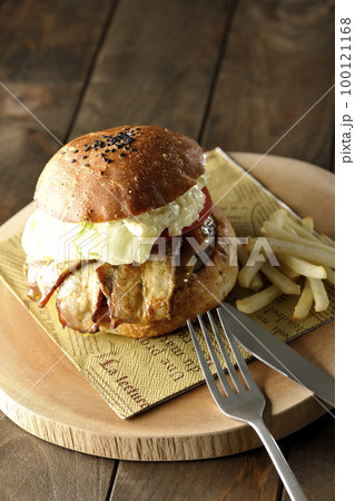 タルタルソースがはみ出ててベーコンとレタスとトマトがはさまったBLTバーガーとフライドポテト タルタルソースがはみ出ててベーコンとレタスとトマトがはさまったBLTバーガーとフライドポテト 100121168