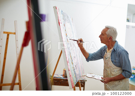 Makers gonna make. Shot of a senior man working on a painting at home. 100122000