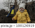 Little girl in front of defensive structures of Ukrainian army. War in Ukraine. Children and war concept. Support for Ukraine. Stop war. Humanitarian disaster concept. Ukrainian flag 100126919