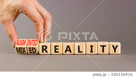 Augmented or mixed reality symbol. Concept words Augmented reality Mixed reality on wooden cubes. Beautiful grey background. Businessman hand. Business augmented or mixed reality concept. Copy space. Augmented or mixed reality symbol. Concept words Augmented reality Mixed reality on wooden cubes. Beautiful grey background. Businessman hand. Business augmented or mixed reality concept. Copy space. 100130416