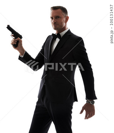 Professional man with gun isolated on a white background for secret service agent, security or criminal businessman. Investigation detective person, boss or crime actor in suit with firearm in studio 100131437