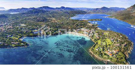 Italy summer holidyas . Sardegna island - stunning Emerald coast (costa smeralda) with beautiful beaches. aerial view of Ira beach with turquoise sea Italy summer holidyas . Sardegna island - stunning Emerald coast (costa smeralda) with beautiful beaches. aerial view of Ira beach with turquoise sea 100131561