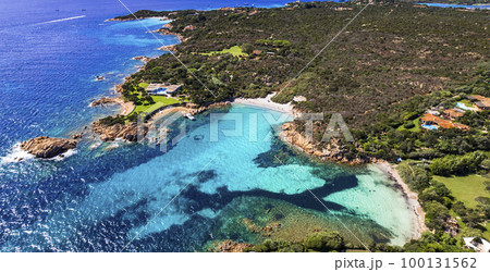 Italy summer holidyas . Sardegna island - stunning Emerald coast (Costa Smeralda) with beautiful beaches. aerial view of small Romazzino beach . 100131562