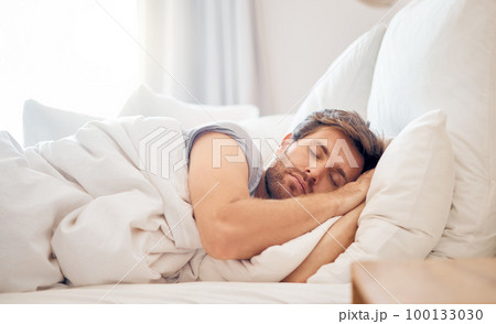 Home, bedroom and sleeping man in the morning lying his head on the pillow in apartment space. Tired, fatigue and relax male taking time off on the weekend in bed of airbnb or hotel accommodation Home, bedroom and sleeping man in the morning lying his head on the pillow in apartment space. Tired, fatigue and relax male taking time off on the weekend in bed of airbnb or hotel accommodation 100133030