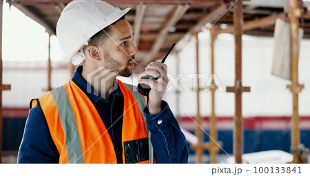 Logistics worker, walkie talkie and man on a construction site working on a building project. Architecture, communication and engineer talking on a radio while doing home maintenance or renovation. 100133841