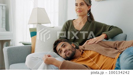 Relax, love and watching tv with couple on sofa for movie, streaming or television subscription. Happy, smile and peace with man on woman legs in living room at home for video, news or film together Relax, love and watching tv with couple on sofa for movie, streaming or television subscription. Happy, smile and peace with man on woman legs in living room at home for video, news or film together 100134242