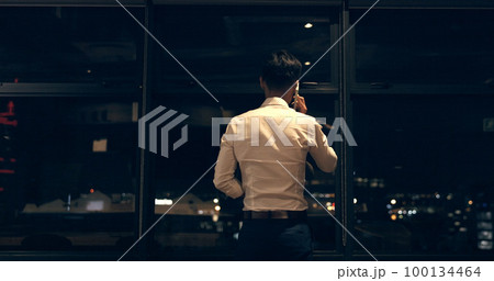 Business man, phone call and window at night in modern office building for global networking or negotiation. Finance, talk strategy rear and corporate worker using phone, communication and city bokeh Business man, phone call and window at night in modern office building for global networking or negotiation. Finance, talk strategy rear and corporate worker using phone, communication and city bokeh 100134464