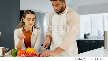 Couple, cooking and together in kitchen and learning for relationship growth and bonding, skill development and support. Young man, woman and cook Italian food, help and advice, spending quality time 100134605