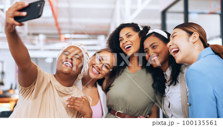 Business women, team and funny selfie with phone for social media, collaboration or startup success together. Female, group and diversity workers taking picture, smartphone or silly friends in office 100135561