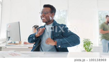 Dance, success and happy black man at work to celebrate a win, achievement and bonus. Smile, cheerful and African employee dancing for business celebration, excited and happiness at a workspace 100138969