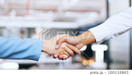 Corporate, partnership and b2b handshake of business people for professional agreement together. Cooperation, welcome or thank you of interracial women employees shaking hands in workplace. 100139865
