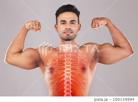 X ray, strong and portrait of a man with muscle isolated on a grey studio background. Spine, anatomy and person showing results from strength workout, training and fitness with power on a backdrop 100139994