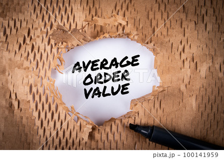 AVERAGE ORDER VALUE. Black marker on torn cardboard background AVERAGE ORDER VALUE. Black marker on torn cardboard background 100141959