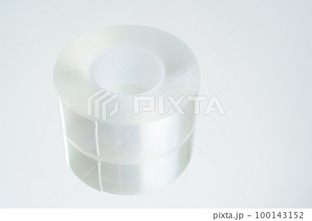 a roll of adhesive transparent tape on a white background.  100143152