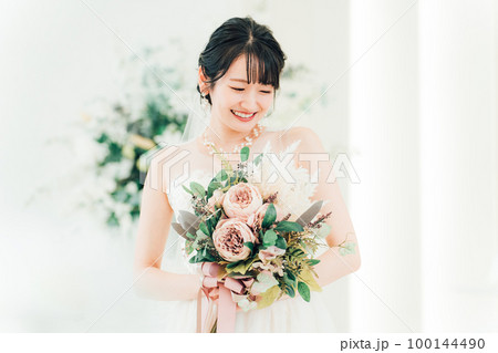 結婚式場でブーケを持つ花嫁・新婦の女性 100144490