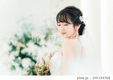 結婚式場でブーケを持つ花嫁・新婦の女性（横顔） 100144766