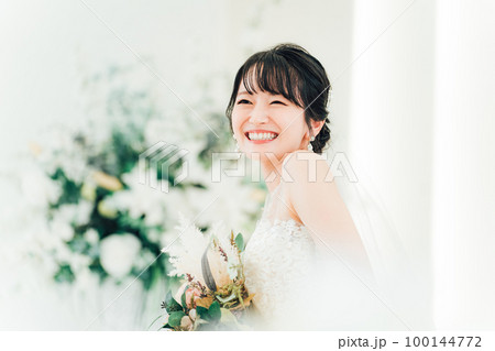結婚式場でブーケを持つ花嫁・新婦の女性（横顔） 100144772