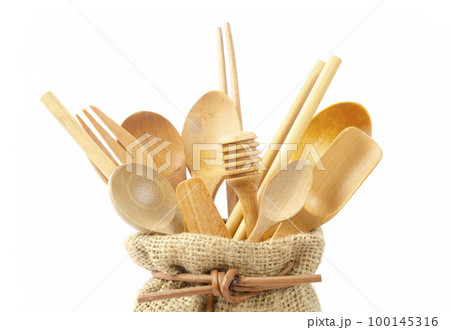 The Close-up wooden cutlery in sack bag on a white background. Environmentally friendly materials. 100145316