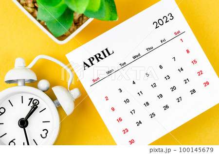 The April 2023 Monthly calendar for 2023 year with alarm clock on yellow background. The April 2023 Monthly calendar for 2023 year with alarm clock on yellow background. 100145679