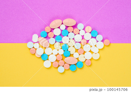 The pile of colorful pills on multicolored background. 100145706