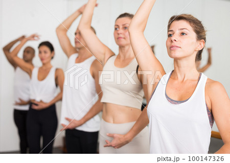 Portrait of european girl ballerina on background of ballet dancers Portrait of european girl ballerina on background of ballet dancers 100147326