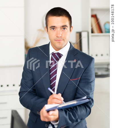 Portrait of positive business man with folder of documents Portrait of positive business man with folder of documents 100148178