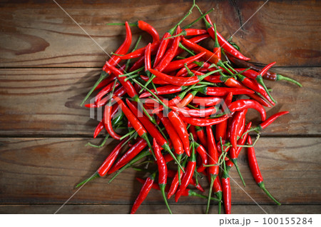 Chili pepper, Red hot chilli peppers on wooden background. Close up group of ripe red chilli 100155284