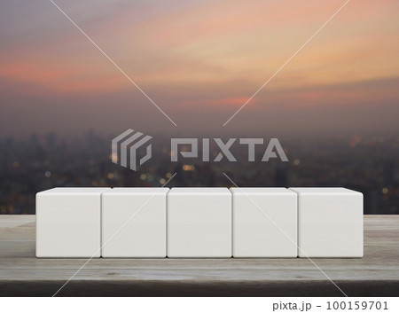 Five white block cubes on wooden table 100159701