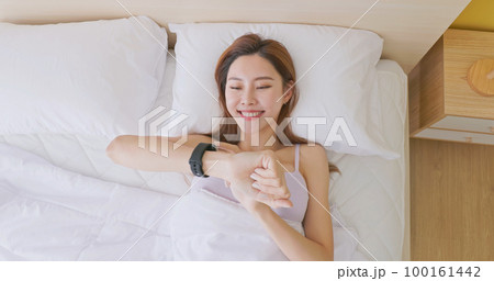 Woman wake up with smartwatch Woman wake up with smartwatch 100161442