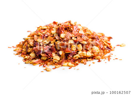 Dry chili pepper flakes. Crushed red peppers isolated on white background. Dry chili pepper flakes. Crushed red peppers isolated on white background. 100162507