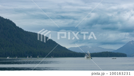 A Fishing boat sailing on the lake. Evergreen forest in the boreal zone. 100163231