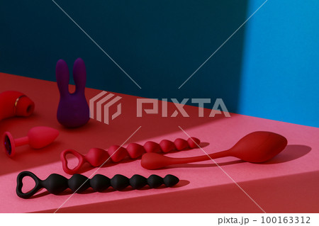 Different adult sex toys such as dildo, vibrator, buttplug on colored background. Sex shop concept 100163312