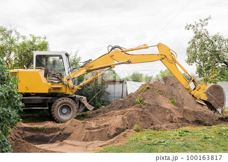 A excavator is digging on outdoors in an industrial site. Excavation works A excavator is digging on outdoors in an industrial site. Excavation works 100163817