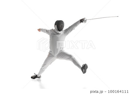 Professional male fencer in fencing costume training with sword isolated on white studio background. Concept of sport, competition, professional skills, achievements 100164111