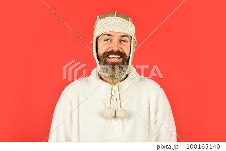 Handsome male model wearing warm hat. casual man in winter hat and warm clothes. happy hipster wear warm hat. cold and flu. Portrait of brutal man in fleece sweatshirt 100165140