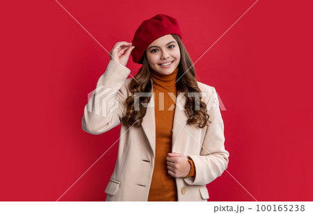 parisian teen girl isolated on red background. parisian teen girl in studio. young parisian girl. 100165238