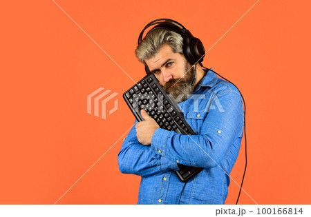 blogger write post. chat online. Online Video Game. Cyber Championship. agile business. downloading music from internet. bearded man headphones and keyboard. Professional Gamer Playing computer game 100166814
