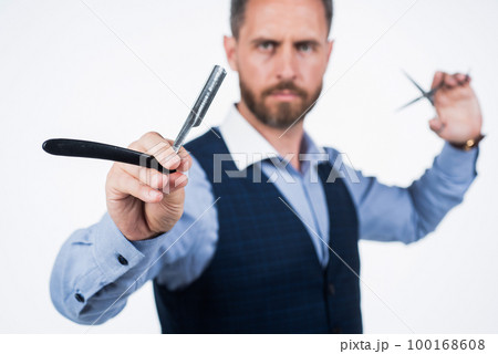 retro razor blade in hand of professional hairdresser, selective focus, hairdressing retro razor blade in hand of professional hairdresser, selective focus, hairdressing 100168608