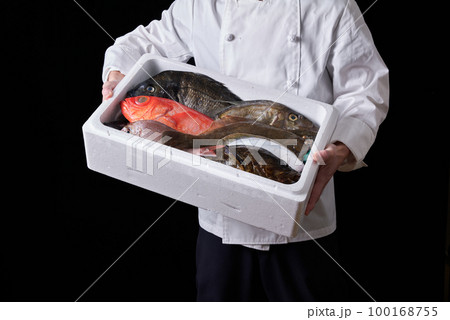 産地から届いた鮮魚を持つシェフ 100168755