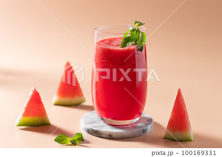 colorful watermelon smoothie with mint in a glass 100169331