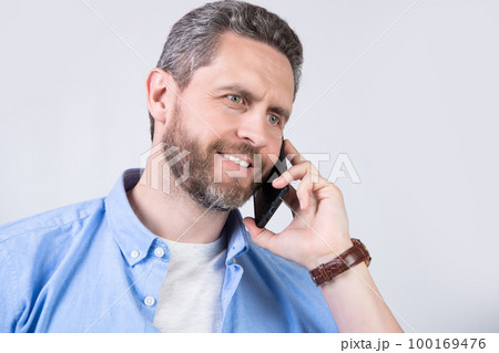 glad man has communication call on phone isolated on studio background. glad man has communication call on phone isolated on studio background. 100169476
