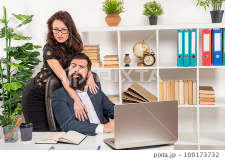 Acting on her feelings. Female boss flirting with male employee. Workplace flirt. Office romance Acting on her feelings. Female boss flirting with male employee. Workplace flirt. Office romance 100173732