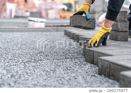 laying interlocking pavers during the construction of sidewalks and roads. copy space laying interlocking pavers during the construction of sidewalks and roads. copy space 100173977