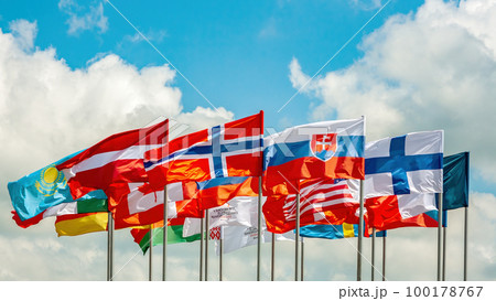 Flags. Many bright flags develop in the wind against the sky. Denmark, Latvia, Finland and others Flags. Many bright flags develop in the wind against the sky. Denmark, Latvia, Finland and others 100178767
