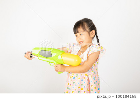 Happy Songkran Day, Asian little girl holding plastic water gun, Thai child funny hold toy water pistol and smile, isolated on white background, Thailand Songkran festival national culture concept 100184169
