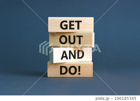 Motivational get out and do symbol. Concept words Get out and do on wooden cubes. Beautiful grey table grey background. Business motivational get out and do concept. Copy space. 100185385